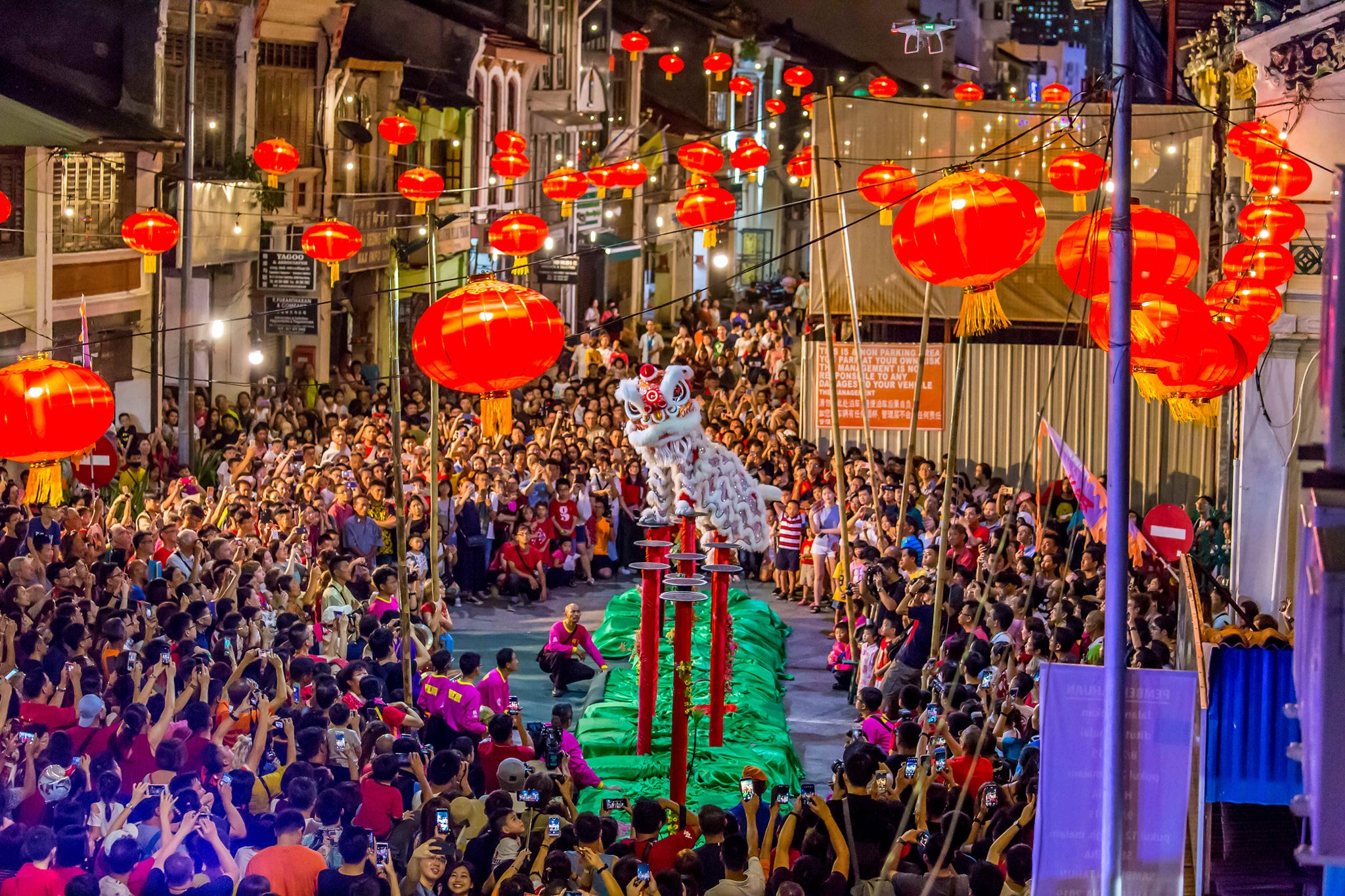 Visitors enjoy a lion dance performance during Chinese New Year in Penang